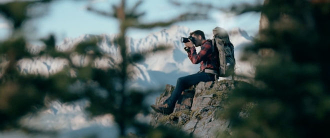 IMAGE: Still – Rack focus through trees, Mike on the edge of the cliff