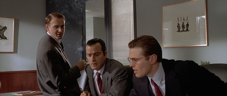 IMAGE: Still - Men looking at cards
